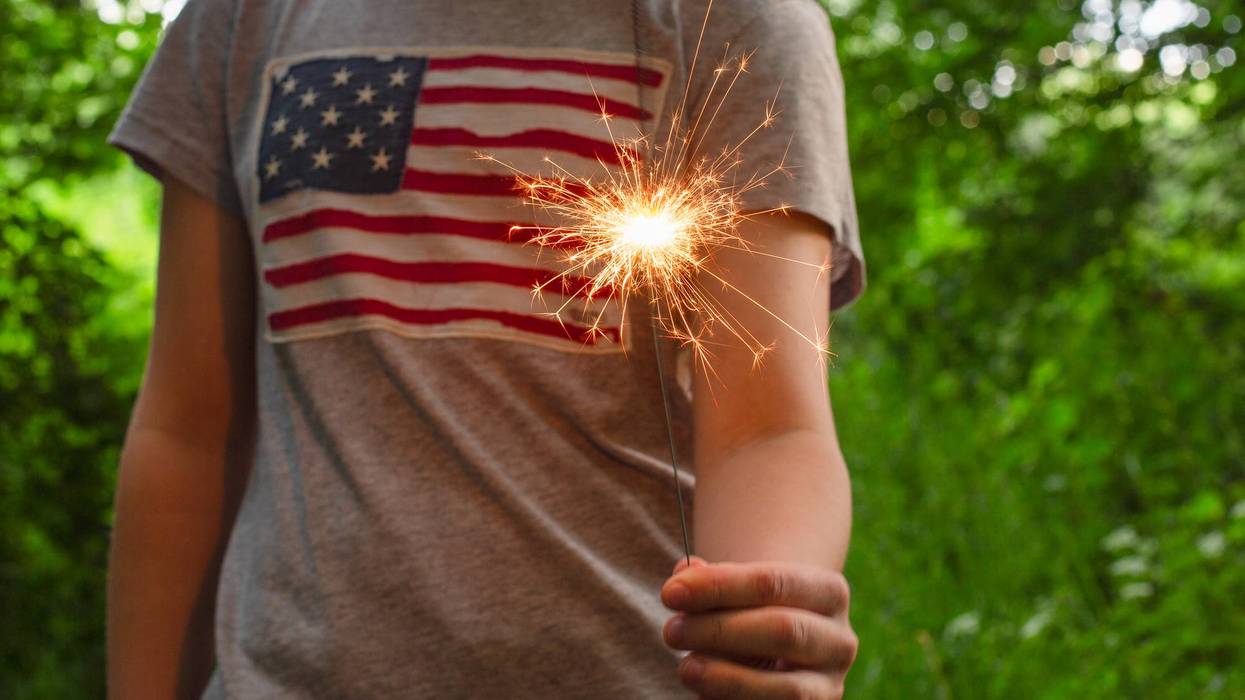 child holding a sparkler