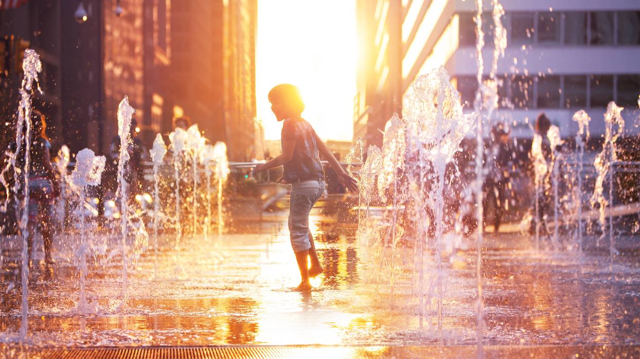Child playing in water fountains at Dilworth Park