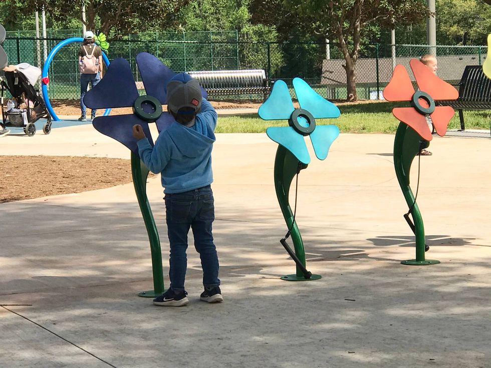 Child plays musical flowers at newly updated Kids Planet