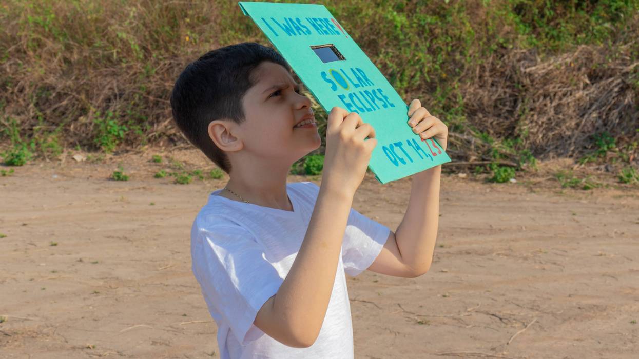 child watching eclipse