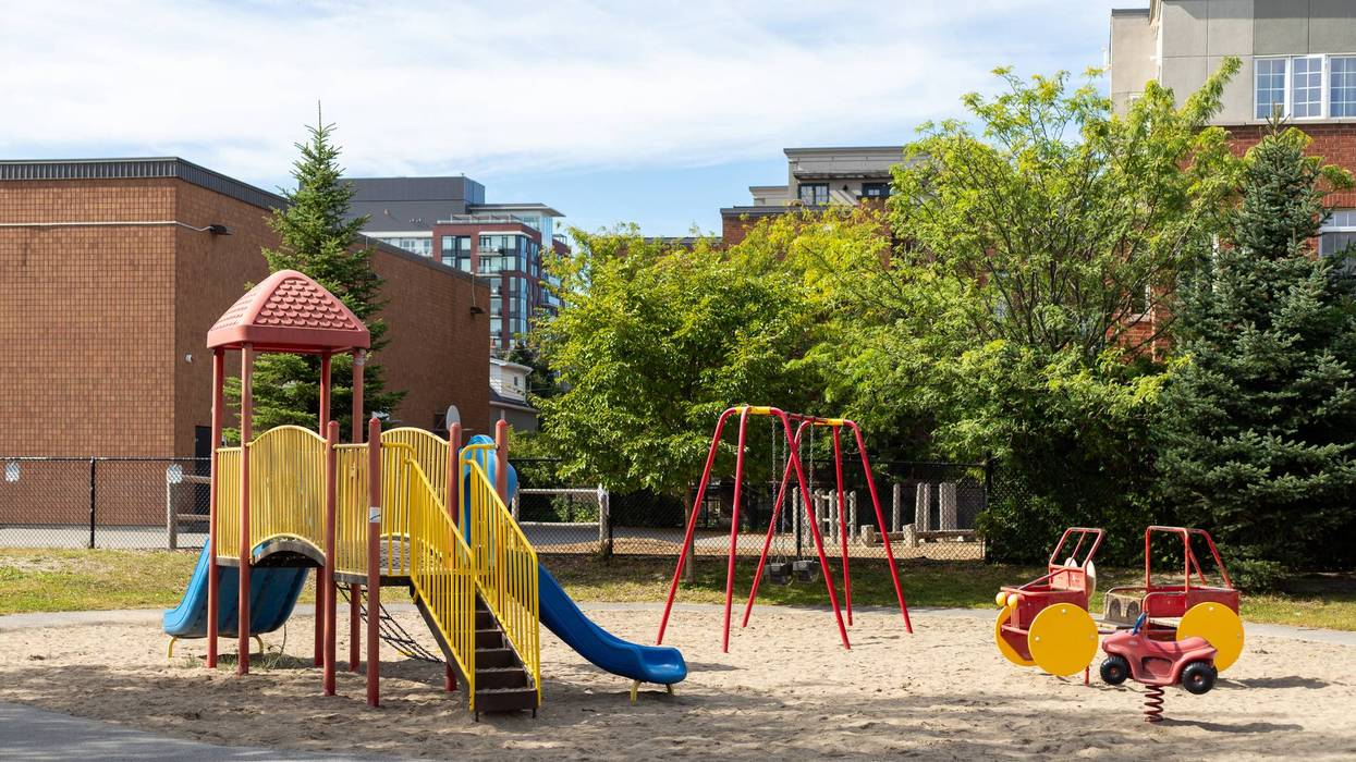 Children playground in park near school yard. Summer break.