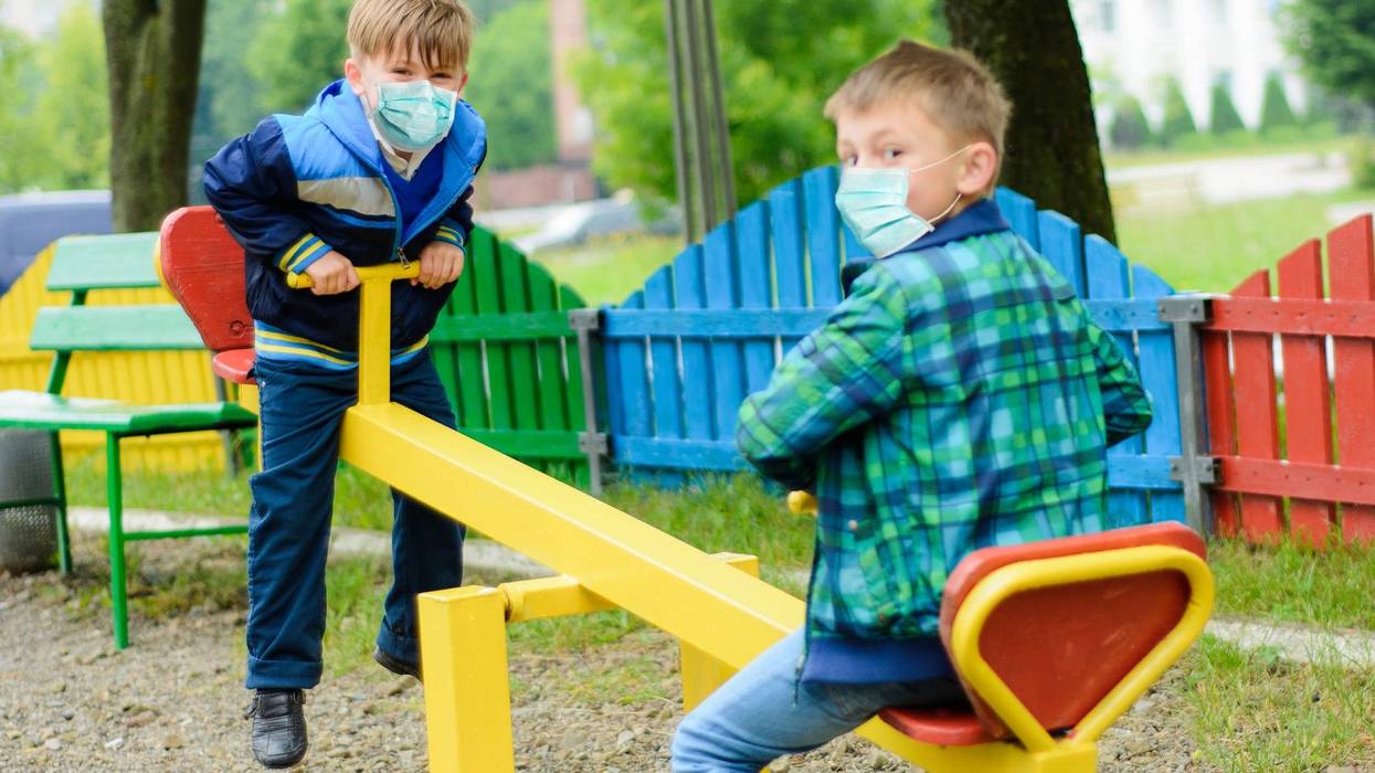 Children wearing face masks in a park.