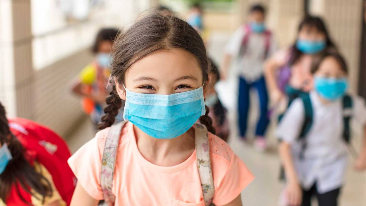 children wearing face medical mask back to school after covid-19 quarantine