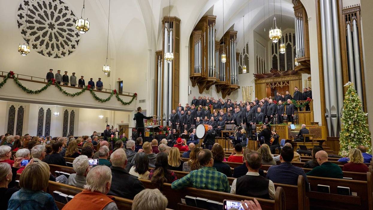 choir performs in front of large crowd in a beautiful sanctuary