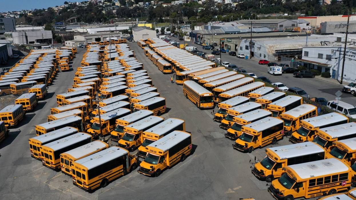 chool buses sit parked in a lot at First Student Charter Bus Rental on July 14, 2020 in San Francisco, California.