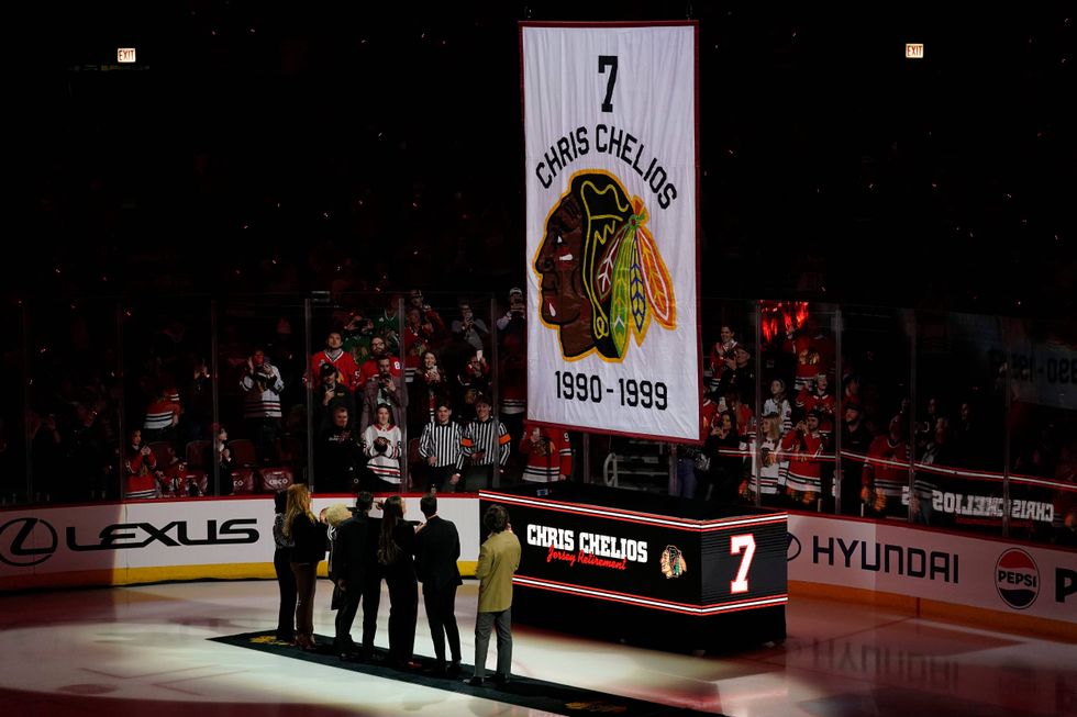 Chris Chelios and his family watch as his number is lifted to the rafters.
