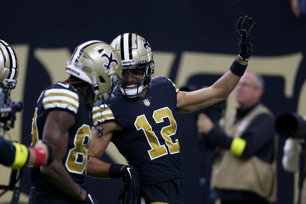 Chris Olave and Rashid Shaheed celebrate a touchdown during a week 18 matchup against the Panthers.