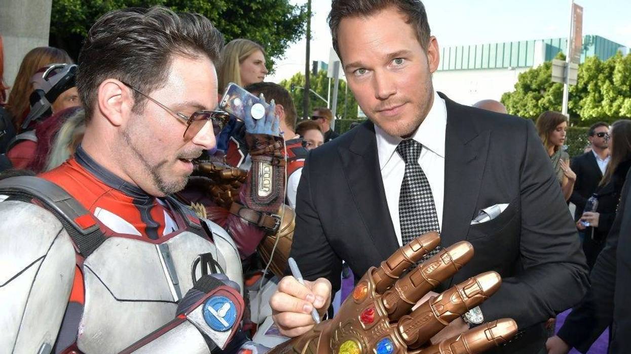 Chris Pratt signs a Thanos gauntlet replica worn by an Iron Man lookalike at the premiere of Avengers: EndGame