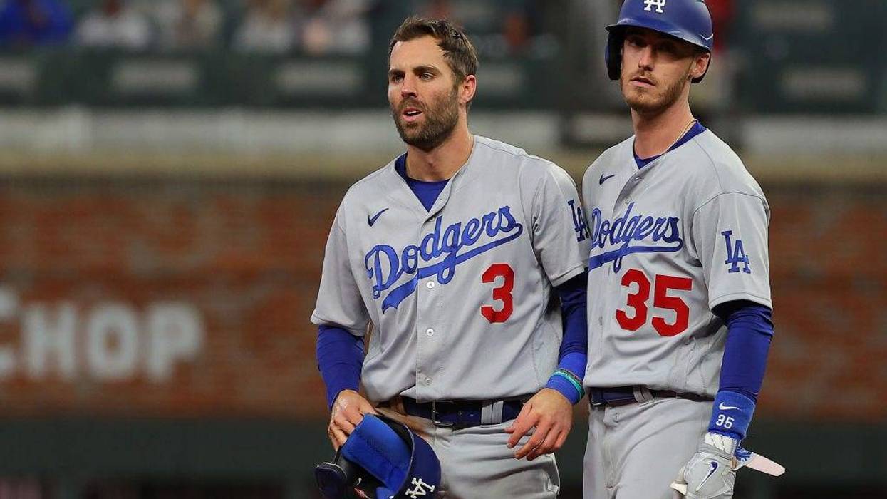Chris Taylor #3 and Cody Bellinger #35 of the Los Angeles Dodgers react against the Atlanta Braves during the ninth inning of Game One of the National League Championship Series.