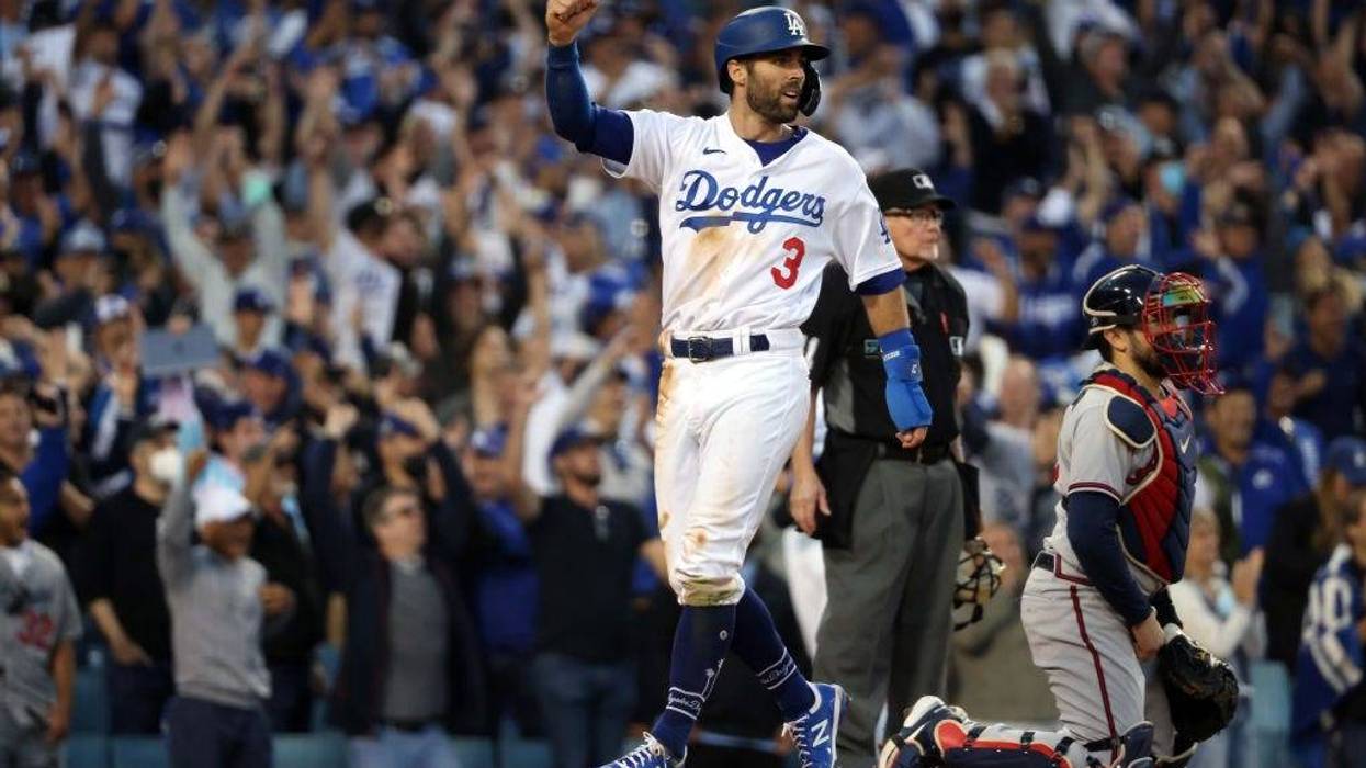 Chris Taylor #3 of the Los Angeles Dodgers score on a double by Mookie Betts #50 during the 8th inning of Game 3 of the National League Championship Series against the Atlanta Braves at Dodger Stadium.