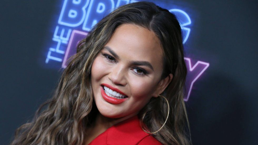 Chrissy Teigen admits she's 'Team Ariana' for 'The Voice' despite John Legend