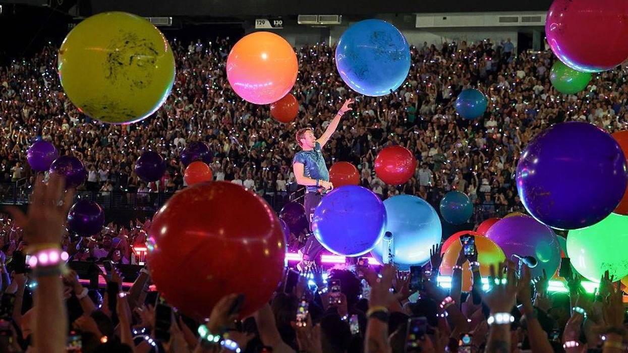 Christ Martin at concert surrounded by colorful spheres