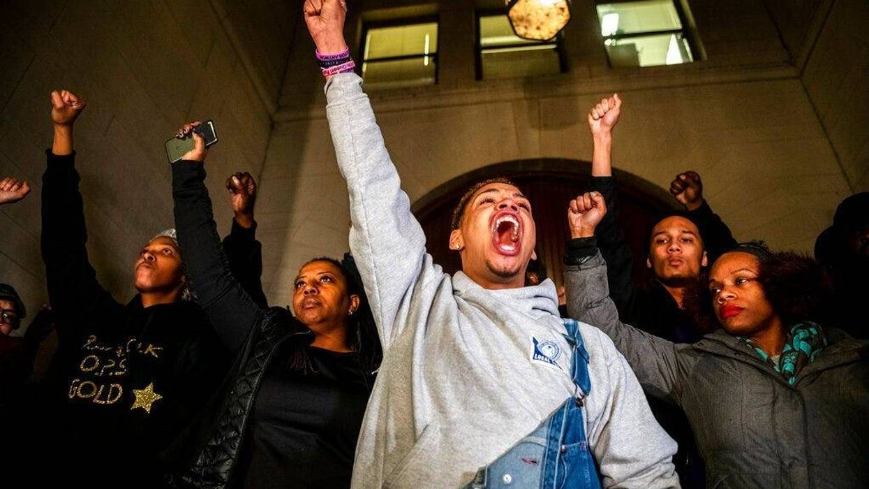 Christian Carter, of Pittsburgh's East Liberty neighborhood, left, leads a chant with other supporters of Antwon Rose II after they learned a not guilty verdict in the homicide trial of former East Pittsburgh police Officer Michael Rosfeld, Friday, March