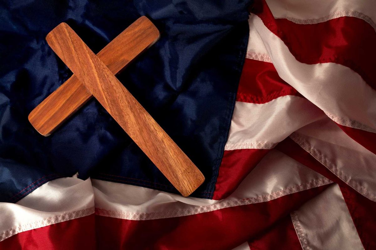 Christian cross on American flag with no stars. Stock photo.