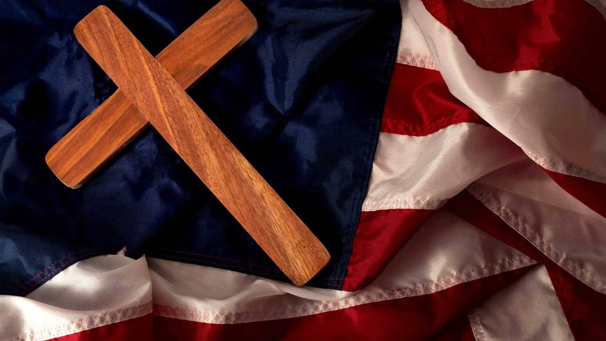 Christian cross on American flag with no stars. Stock photo.