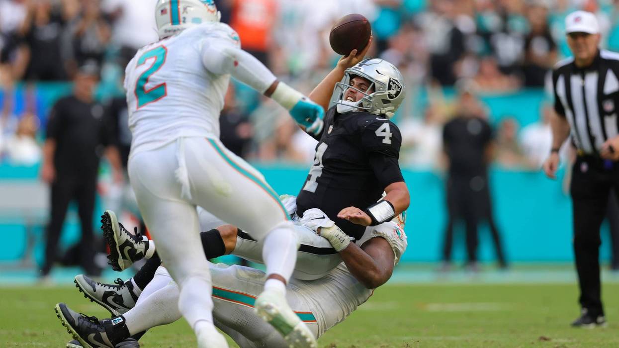: Christian Wilkins #94 of the Miami Dolphins tackles Aidan O'Connell #4 of the Las Vegas Raiders during the fourth quarter at Hard Rock Stadium on November 19, 2023 in Miami Gardens, Florida.