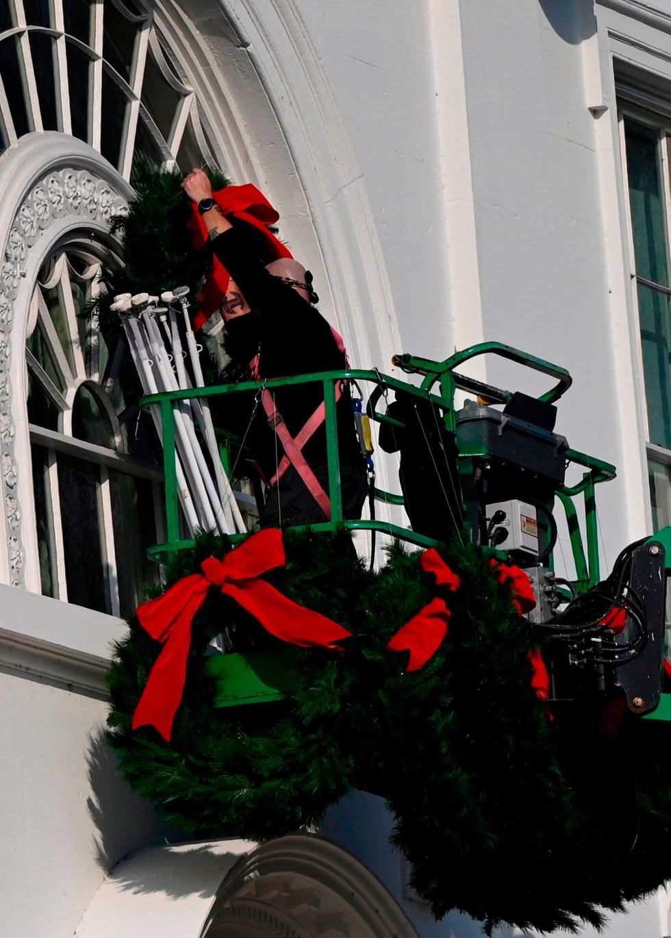 Christmas wreaths are installed at the White House in Washington, DC, on November 21, 2020.