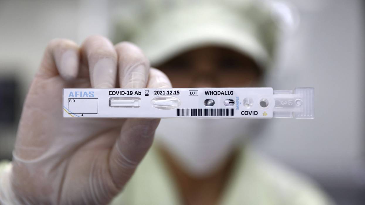 CHUNCHEON, SOUTH KOREA - APRIL 17: An employee holds up an AFIAS Covid-19 Ab testing kit used in diagnosing the coronavirus (COVID-19) at the Boditech Med Inc. headquarters on April 17, 2020 in Chuncheon, South Korea.