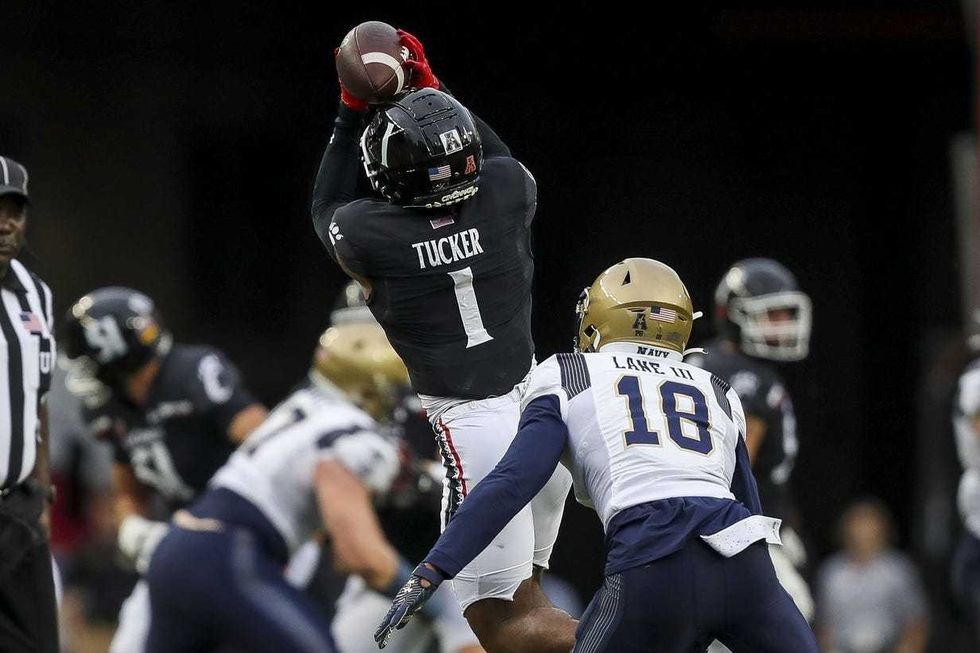 Cincinnati Bearcats wide receiver Tre Tucker (1) catches a pass against Navy Midshipmen safety Rayuan Lane III (18) in the first half at Nippert Stadium.