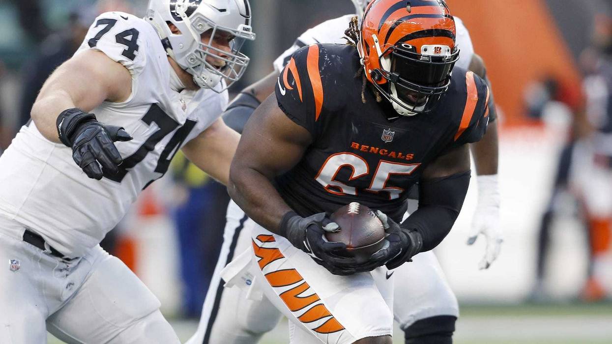 Cincinnati Bengals defensive tackle Larry Ogunjobi (65) picks up the fumble as Las Vegas Raiders offensive tackle Kolton Miller (74) goes for the tackle