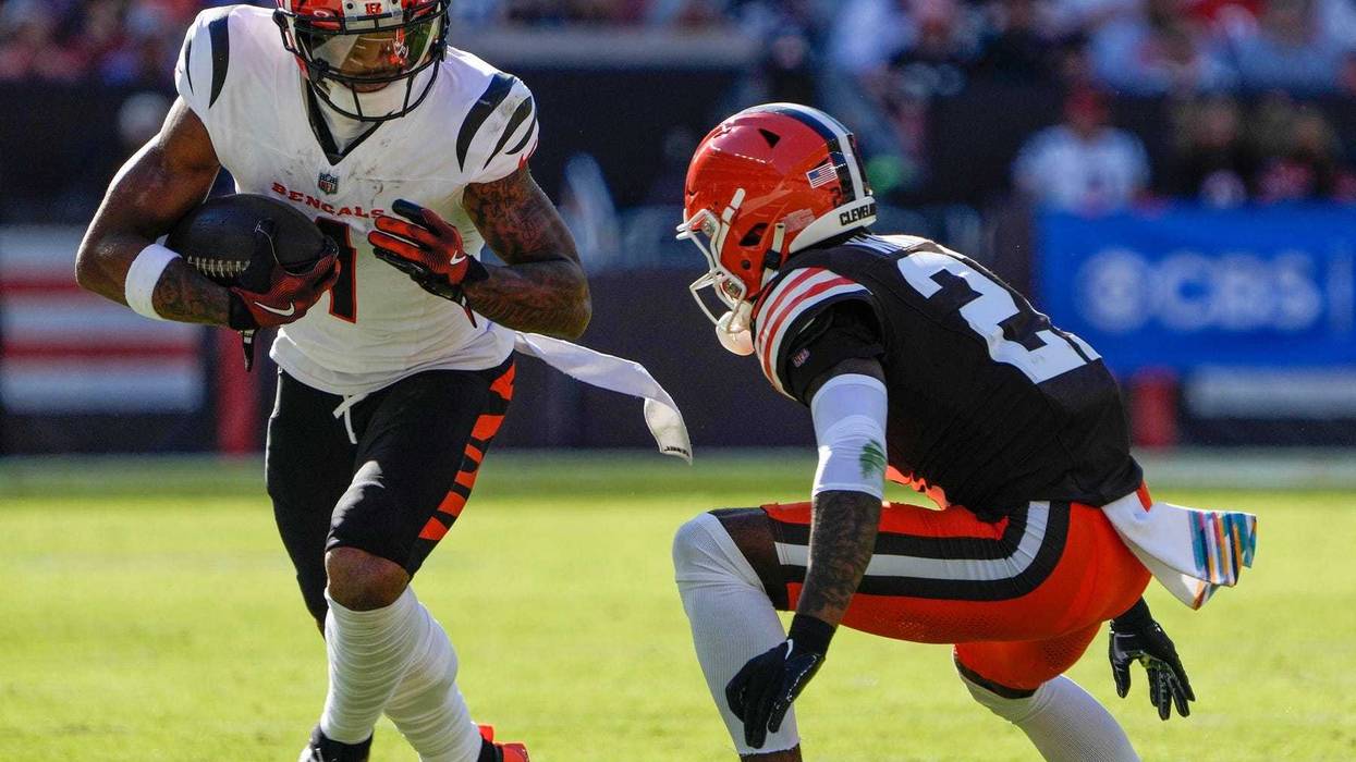 Cincinnati Bengals wide receiver Ja'Marr Chase (1) runs the ball past Cleveland Browns cornerback Denzel Ward (21) in the NFL Week 7 game at Huntington Bank Field in Cleveland October 20, 2024. The Bengals won 21-14.