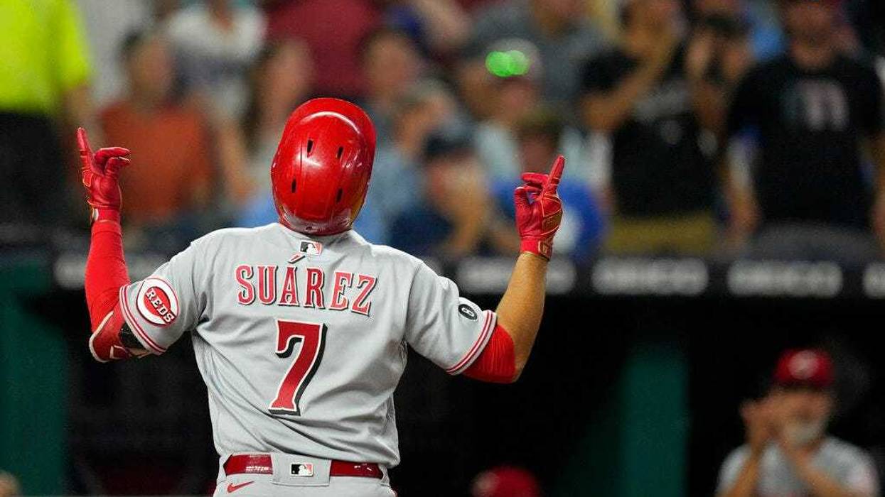 Cincinnati Reds' Eugenio Suarez celebrates after hitting a three-run home run during the seventh inning