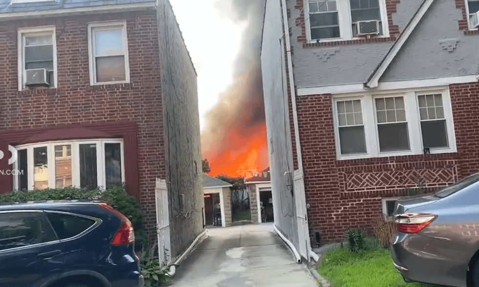 Citizen App footage shows hot orange flames from the rear of a row of attached houses in Queens that burned on Saturday.