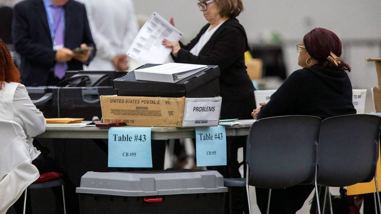 City of Detroit election workers tabulate absentee voters' ballots at Huntington Place on October 29, 2024 in Detroit, Michigan.