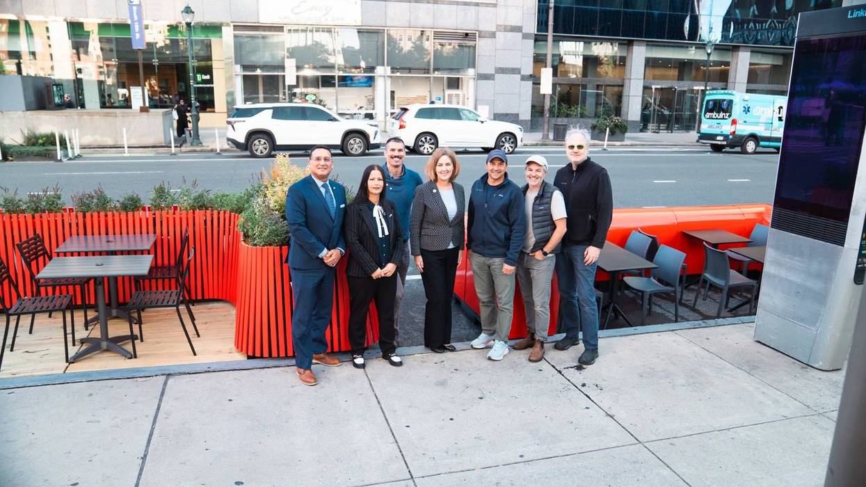 City officials stand next to streetery prototype designs at 15th Street and JFK Boulevard.