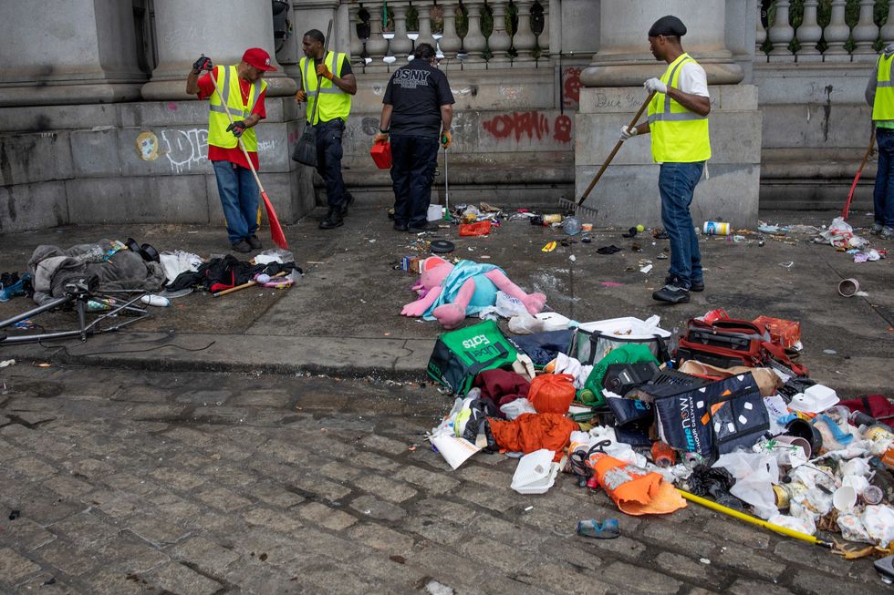 City workers remove the debris from a homeless encampment on September 22, 2022 in New York City.