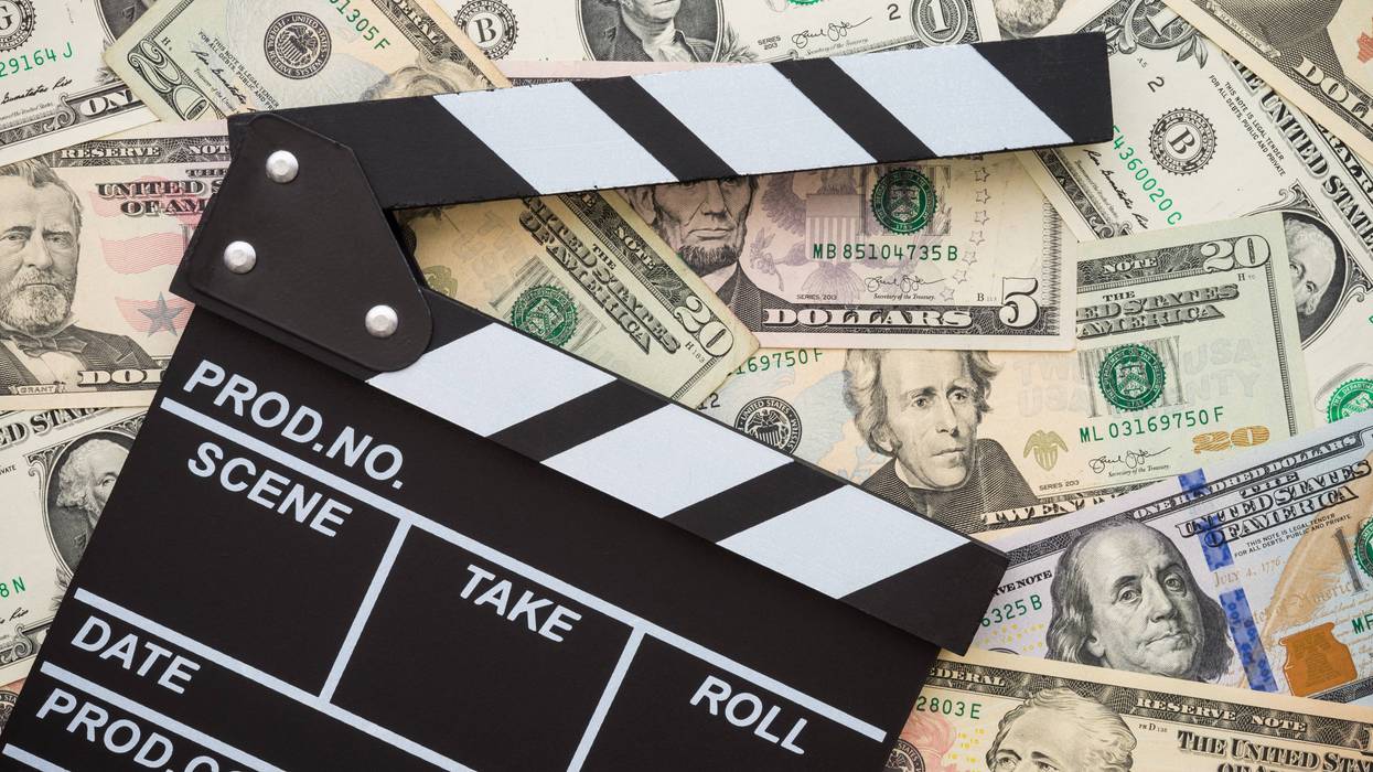clapboard on stack of money