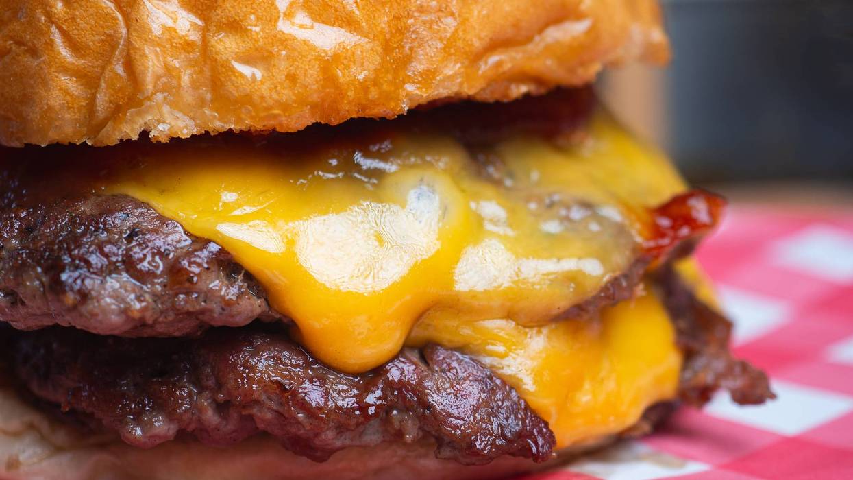 Classic grilled hamburger stacked with juicy beef, cheddar cheese, and toasted brioche bun.