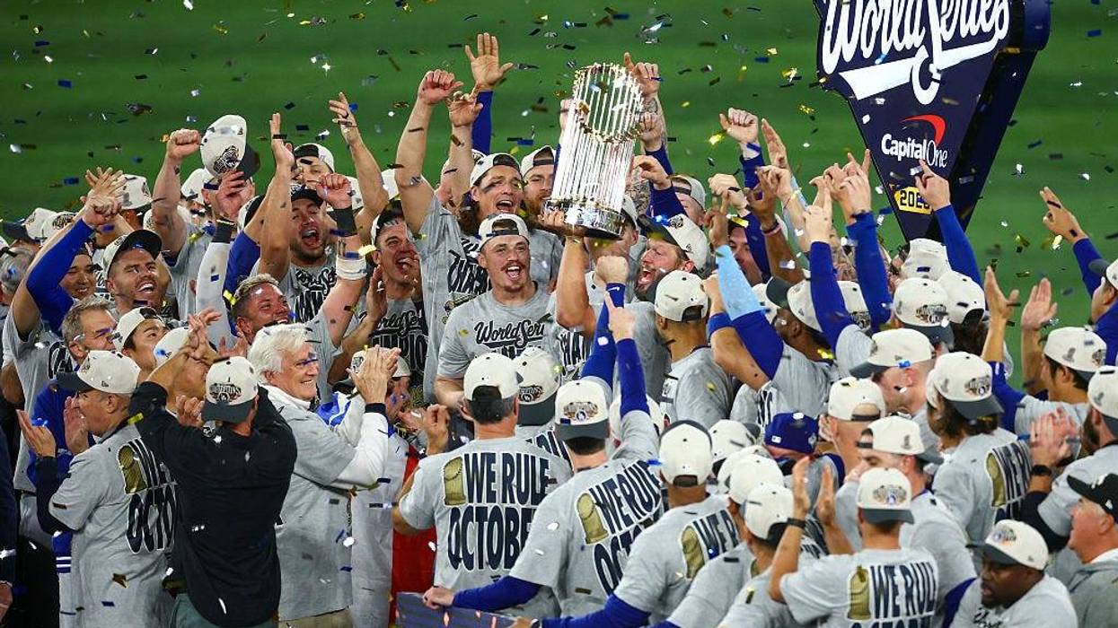 Clayton Kershaw #22 of the Los Angeles Dodgers raises the Commisioner's Trophy after defeating the Toronto Blue Jays 5-4 in game seven of the 2025 World Series at Rogers Center on November 02, 2025 in Toronto, Ontario.