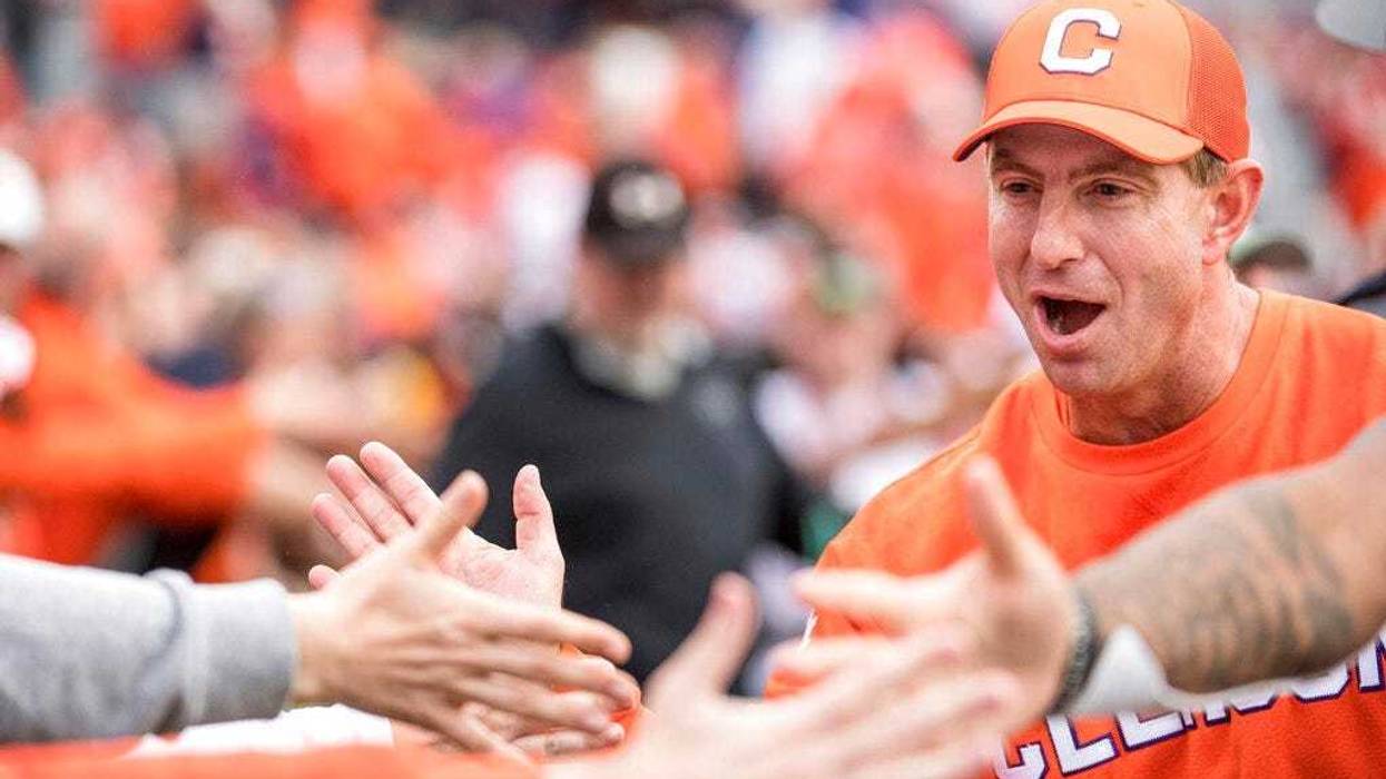 Clemson head coach Dabo Swinney high-fives fans after an NCAA college football game against South Carolina, Saturday, Nov. 30, 2019, in Columbia, S.C. Clemson won 38-3.