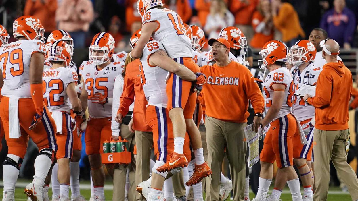Clemson quarterback Trevor Lawrence (16) is greeted defensive tackle Jordan Williams (59) and head coach Dabo Swinney during the fourth quarter in the 2019 College Football Playoff cChampionship game against Alabama on Jan. 6, 2018, in Santa Clara, Calif.