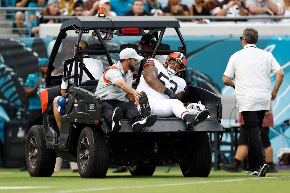 Cleveland Browns center Nick Harris (53) is carted off the field during the first quarter of a preseason game against the Jacksonville Jaguars at TIAA Bank Field.