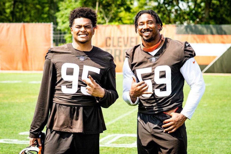 Cleveland Browns defensive end Curtis Weaver (L) poses with defensive end Myles Garrett (R) after swapping jerseys for Friday