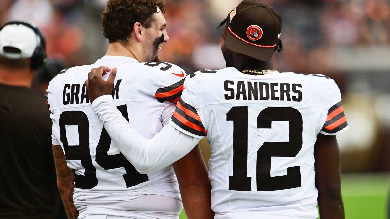 Cleveland Browns defensive tackle Mason Graham (94) and quarterback Shedeur Sanders (12) talk on the sidelines during the first half against the Los Angeles Rams at Huntington Bank Field