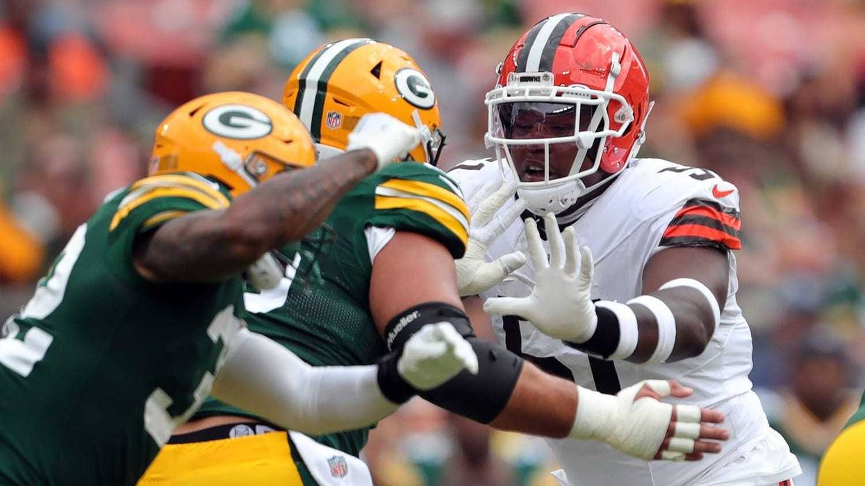 Cleveland Browns defensive tackle Mike Hall Jr. (51) works around a pair of Green Bay Packers players during the first half of an NFL preseason football game at Cleveland Browns Stadium, Saturday, Aug. 10, 2024, in Cleveland, Ohio.