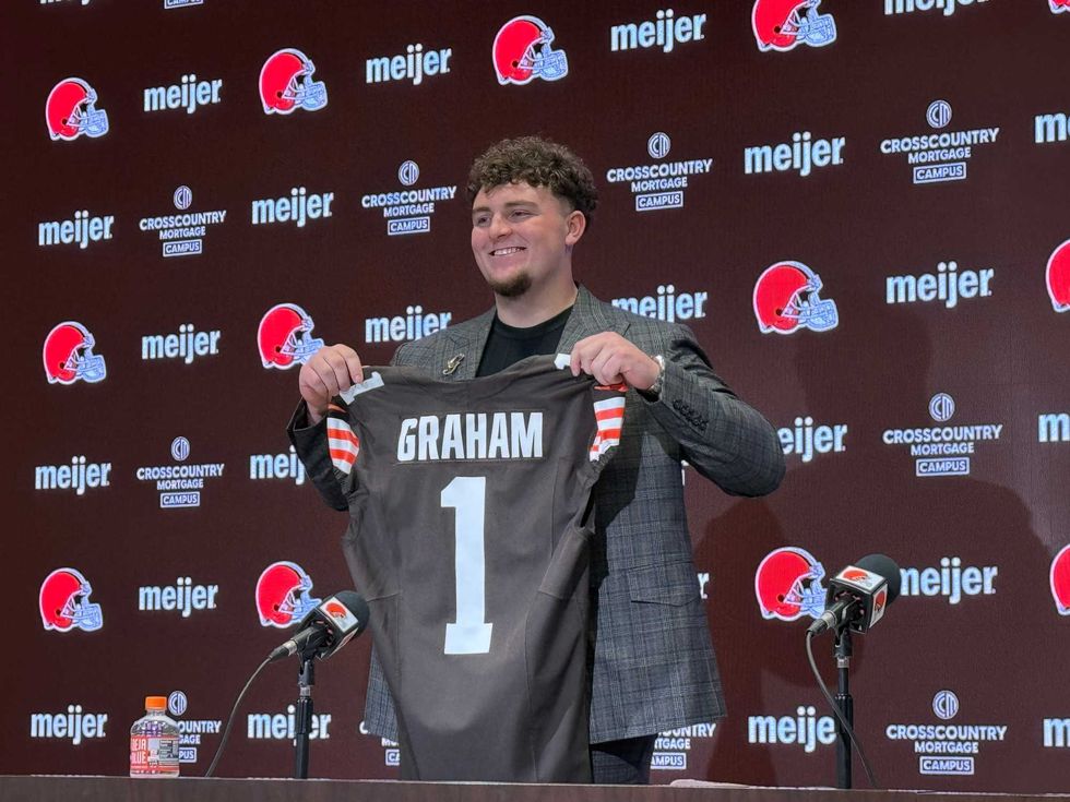 Cleveland Browns first-round pick Mason Graham, a defensive tackle from Michigan, holds up a commemorative jersey following his introductory press conference on April 25, 2025.