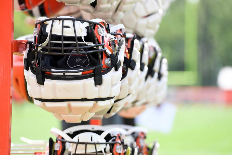 Cleveland Browns helmets, with Guardian Caps, hang from a rack during the NFL football team