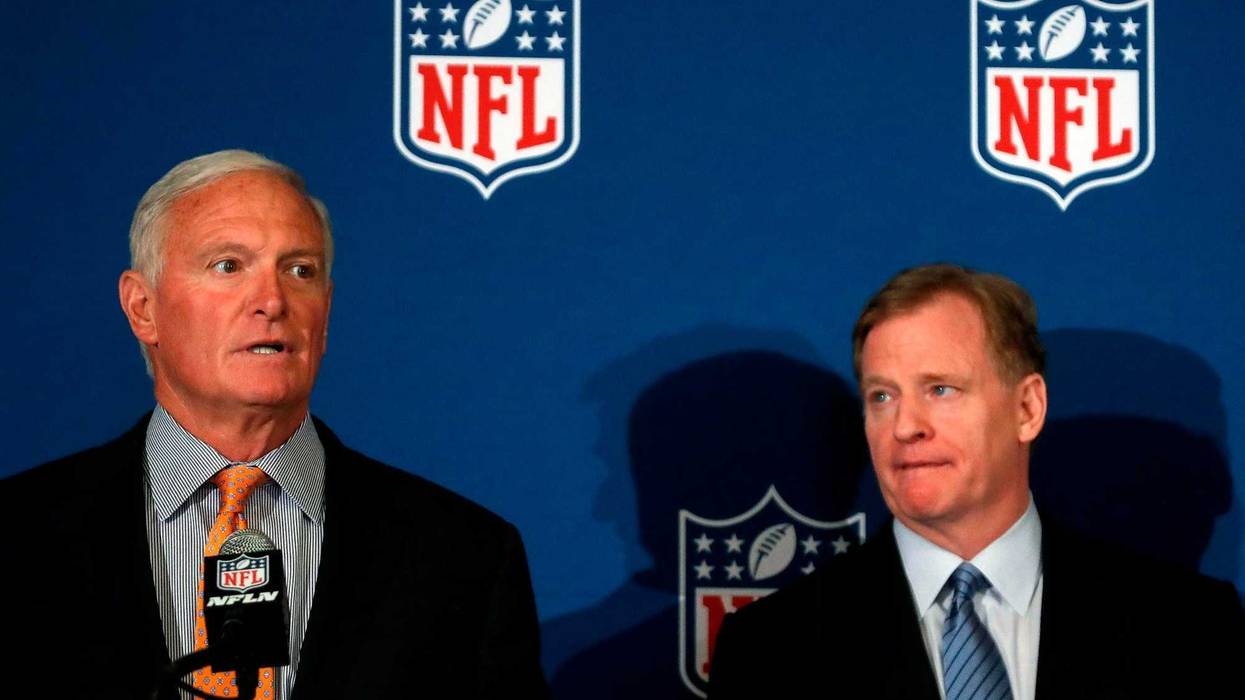Cleveland Browns owner Jimmy Haslam speaks as NFL commissioner Roger Goodell looks on at right after they announced NFL team owners have reached agreement on a new league policy that requires players to stand for the national anthem or remain in the locke