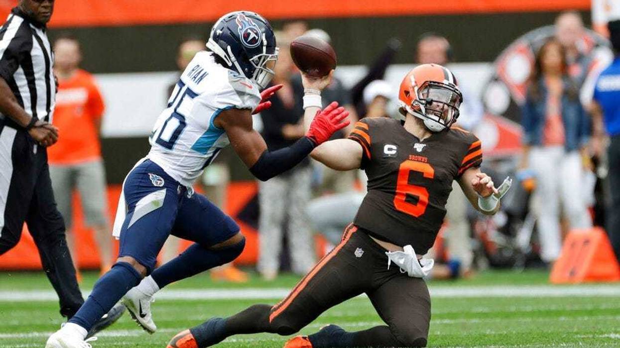 Cleveland Browns quarterback Baker Mayfield (6) throws under pressure from Tennessee Titans cornerback Logan Ryan (26) during the first half in an NFL football game, Sunday, Sept. 8, 2019, in Cleveland.