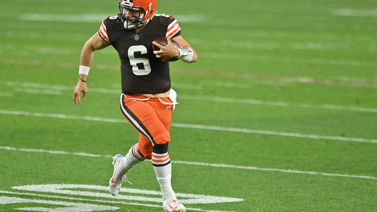 Cleveland Browns quarterback Baker Mayfield runs for a first down during the first quarter against the Cincinnati Bengals at FirstEnergy Stadium.