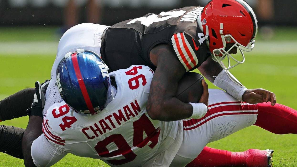 Cleveland Browns quarterback Deshaun Watson (4) is sacked by /New York Giants defensive tackle Elijah Chatman (94) during the first half of an NFL football game at Huntington Bank Field, Sunday, Sept. 22, 2024, in Cleveland, Ohio.