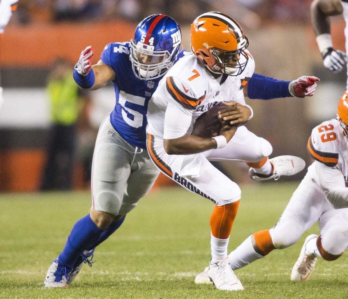 Cleveland Browns quarterback DeShone Kizer (7) is sacked by New York Giants defensive end Olivier Vernon (54) during the second quarter at FirstEnergy Stadium.