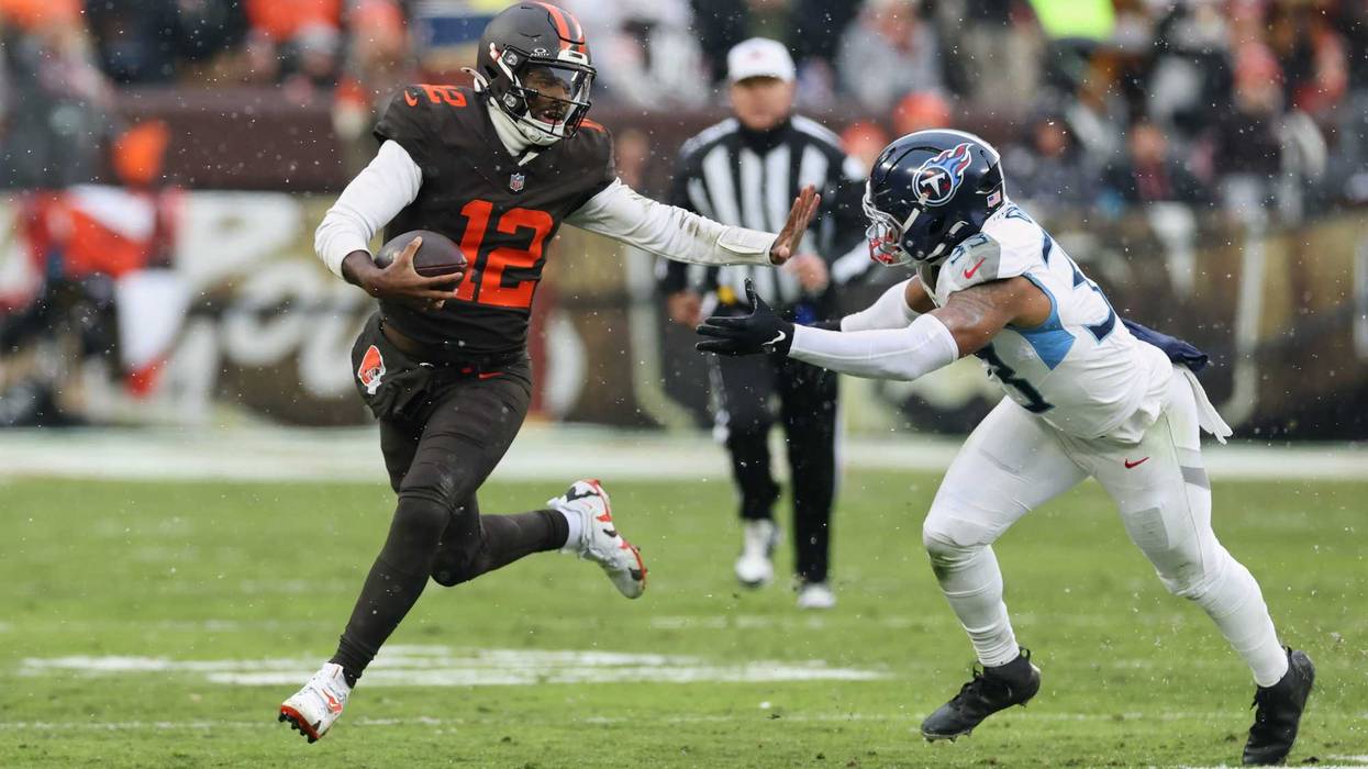 Cleveland Browns quarterback Shedeur Sanders (12) runs with the ball against Tennessee Titans linebacker Cedric Gray (33) during the second quarter at Huntington Bank Field.