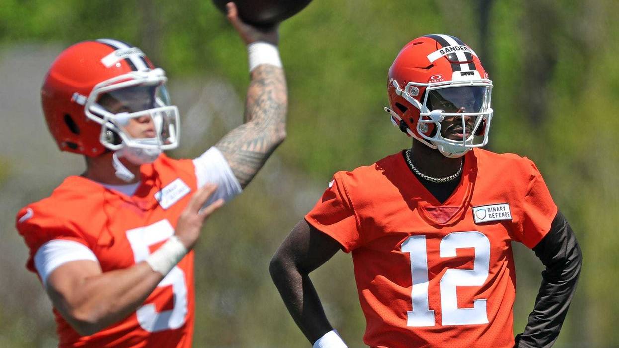 Cleveland Browns quarterback Shedeur Sanders (12) watches as quarterback Dillon Gabriel (5) throws during NFL rookie minicamp at the Cleveland Browns training facility on Friday, May 9, 2025, in Berea, Ohio.