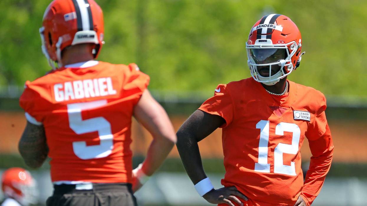 Cleveland Browns quarterback Shedeur Sanders (12) watches quarterback Dillon Gabriel (5) during day two of NFL rookie minicamp at the Cleveland Browns training facility on Saturday, May 10, 2025, in Berea, Ohio.