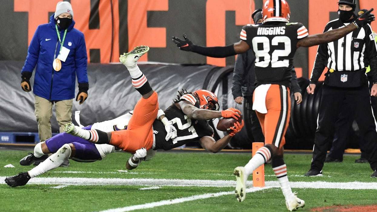 Cleveland Browns running back Kareem Hunt (27) dives for a touchdown as wide receiver Rashard Higgins (82) begins to celebrate during the second half against the Baltimore Ravens at FirstEnergy Stadium.